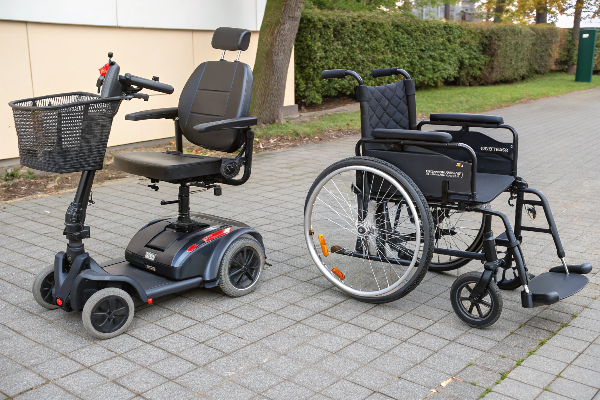 A mobility scooter next to a manual wheelchair