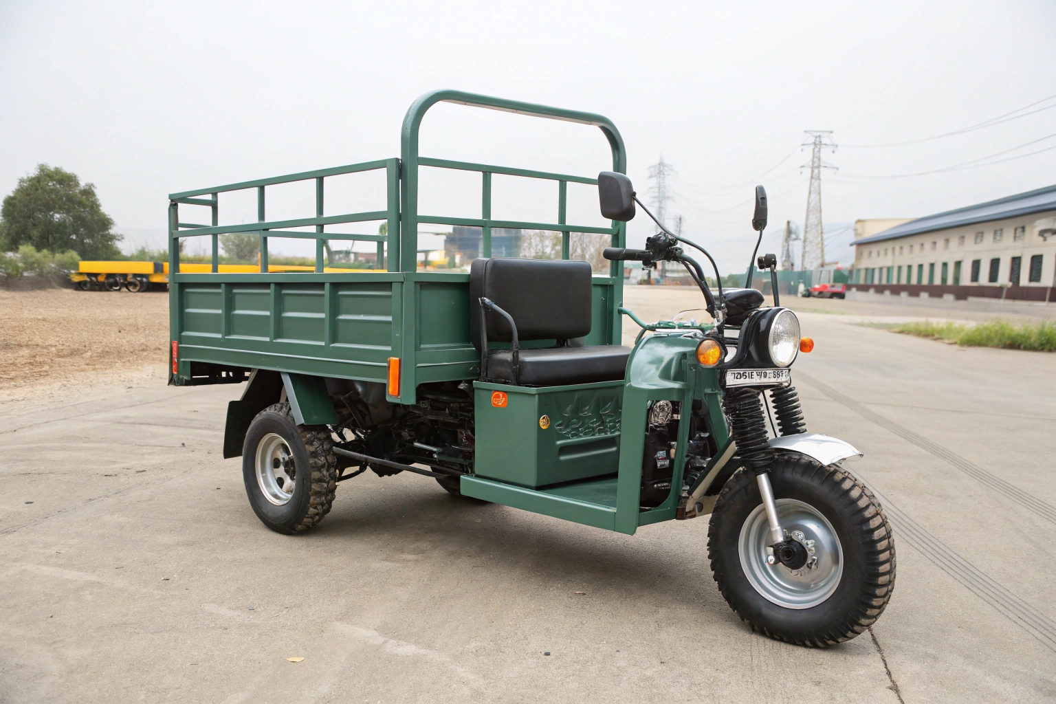 A close-up shot of the heavy-duty hydraulic lift mechanism on an electric farm tricycle's cargo bed.
