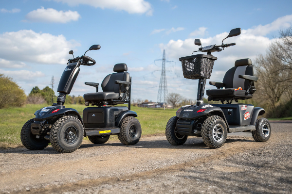 A rugged, all-terrain mobility scooter on a dirt path in the countryside