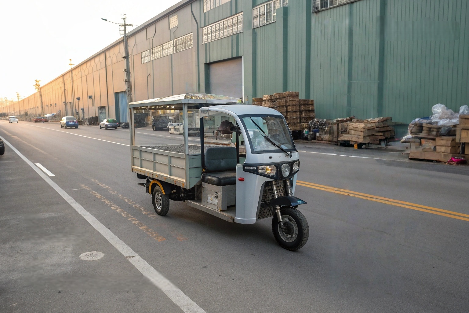 a fleet of identical electric 3 wheel vans lined up at a charging station