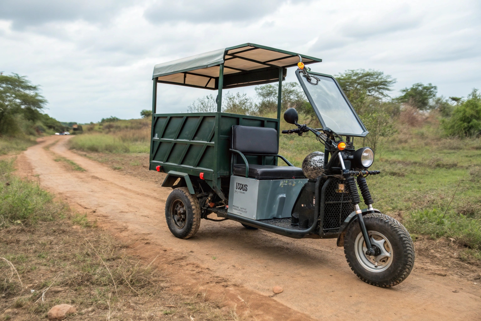 a close-up shot of a heavy-duty suspension and rugged tire on an electric garbage tricycle