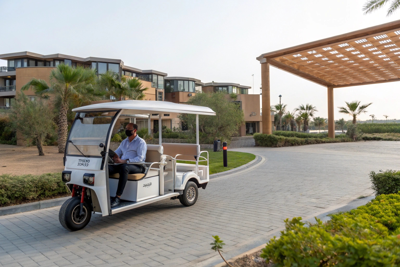 Happy passengers riding in a branded Bajaj style e-tuk taxi