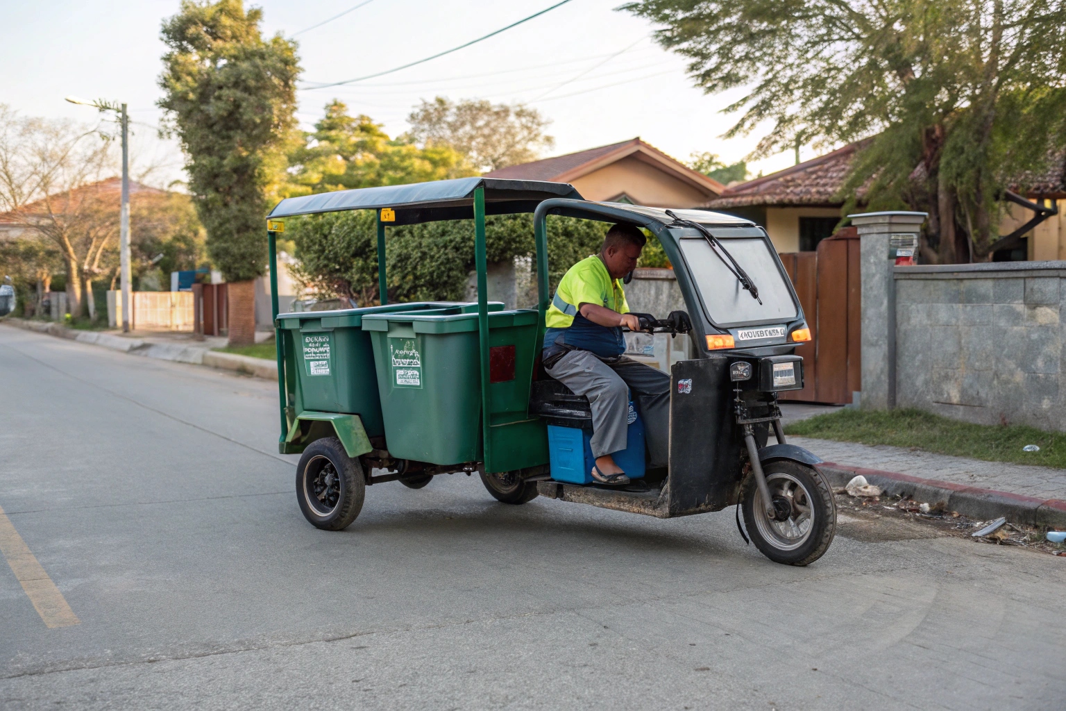 A mix of a small electric garbage truck and a tricycle working together