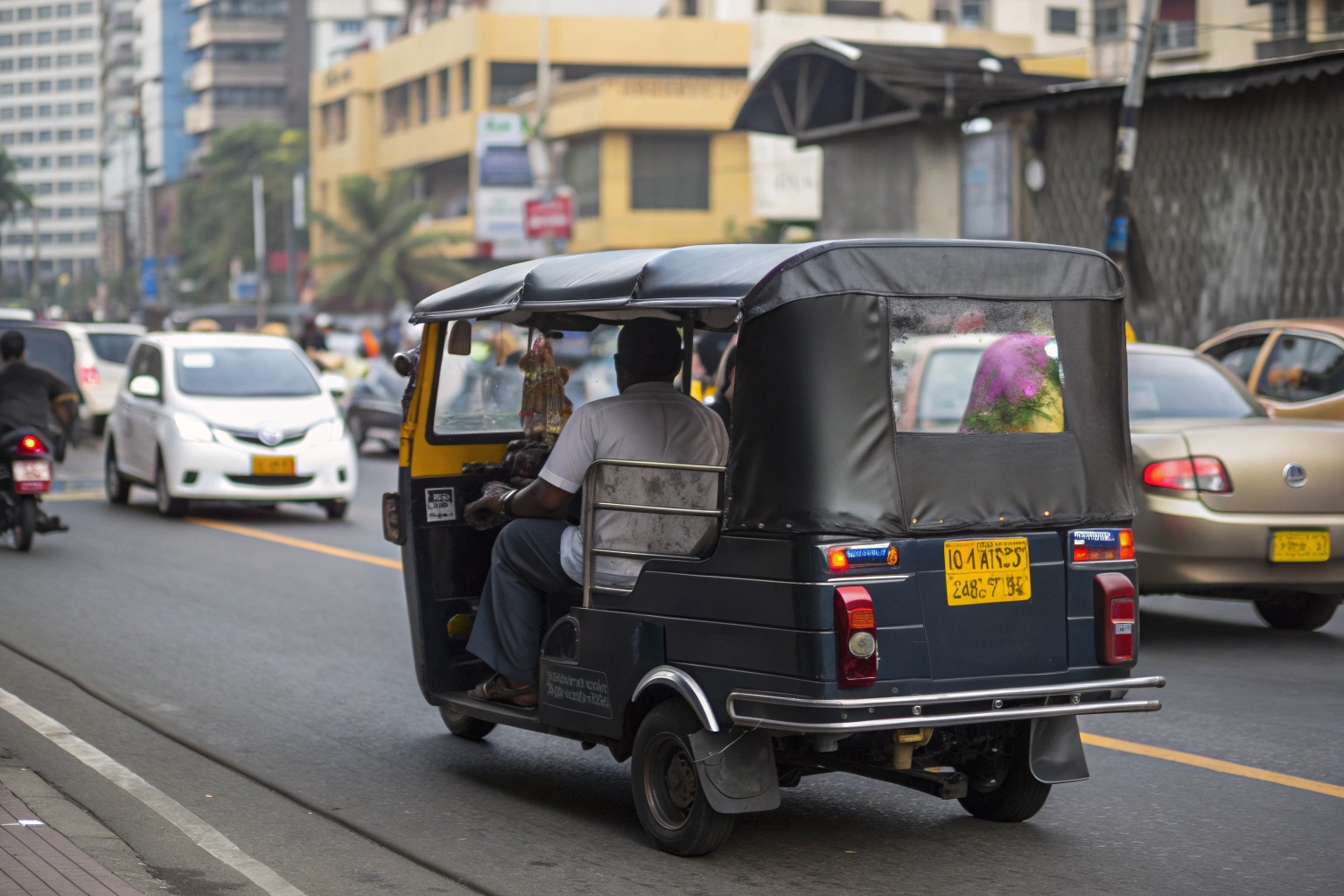 An electric passenger tuk-tuk moving at a moderate speed on a city street