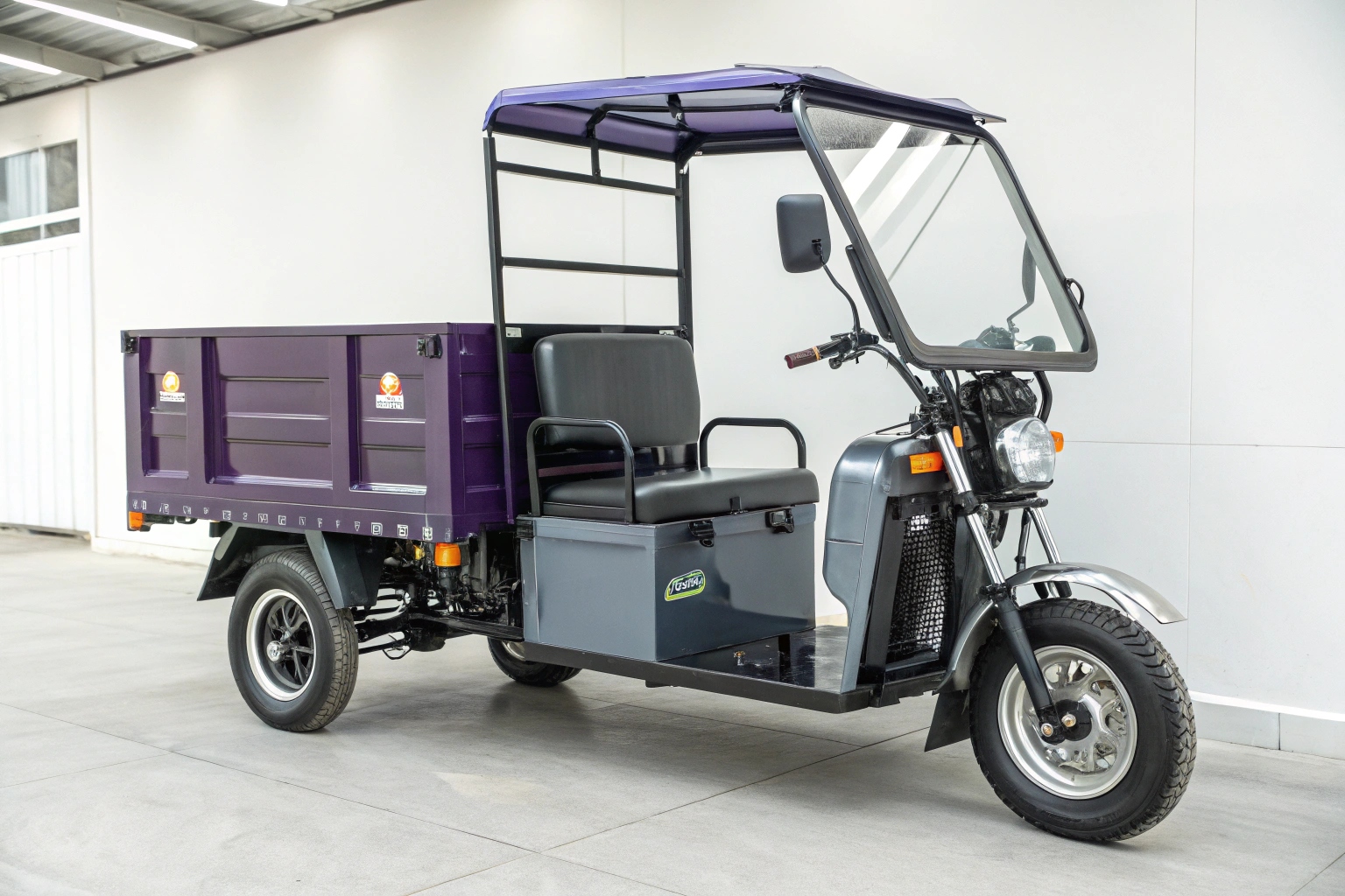 a close-up of the front wheel and steering mechanism of an AGL garbage tricycle