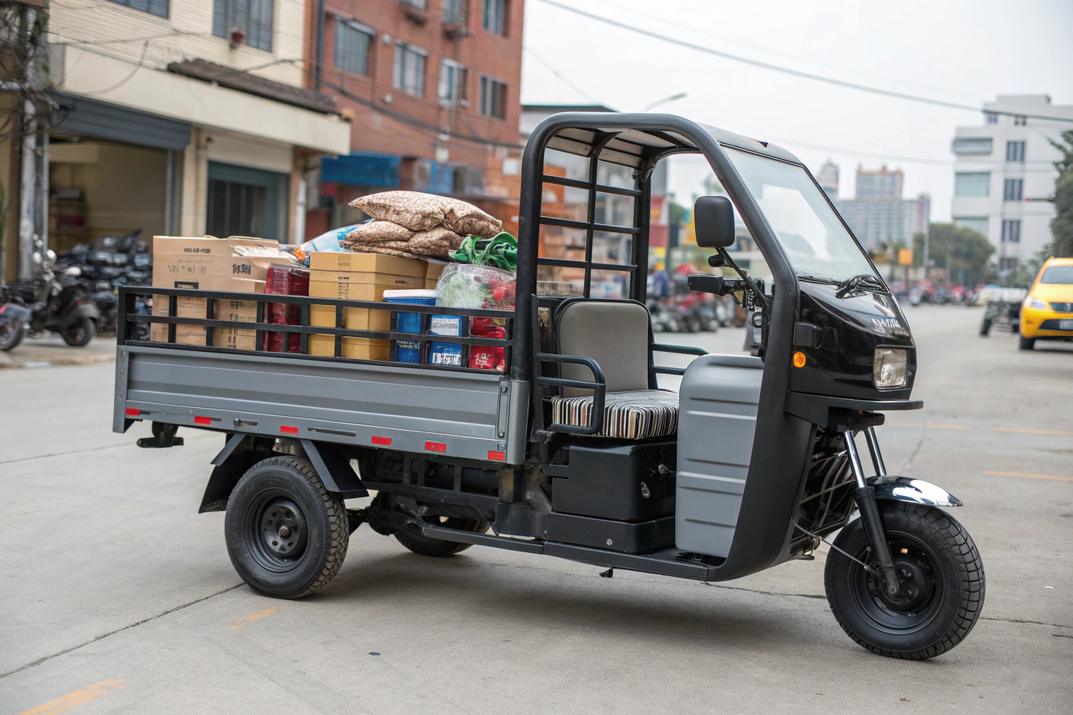 a tricycle van with its rear doors open, showing it fully loaded with delivery packages