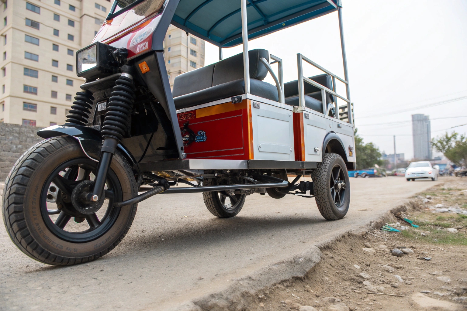 A cargo electric tricycle navigating a bumpy road with its load remaining stable