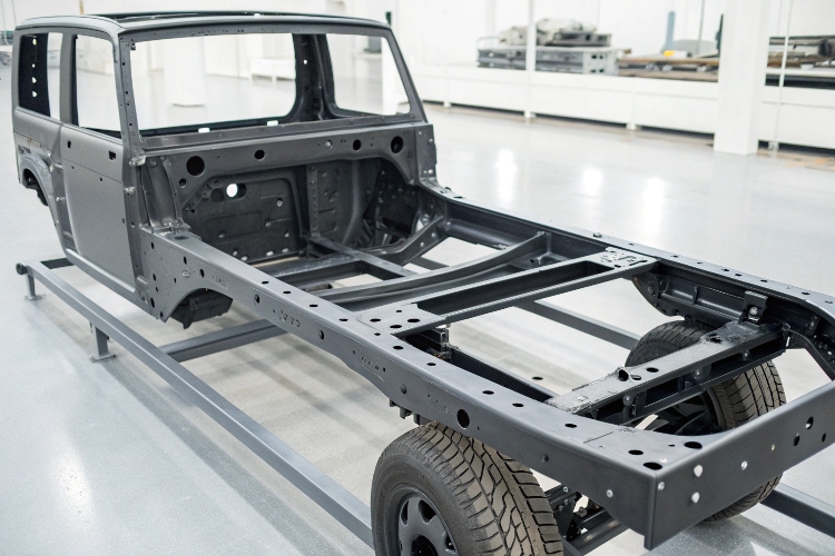 A chassis frame being treated with an electrophoretic anti-rust coating in a factory