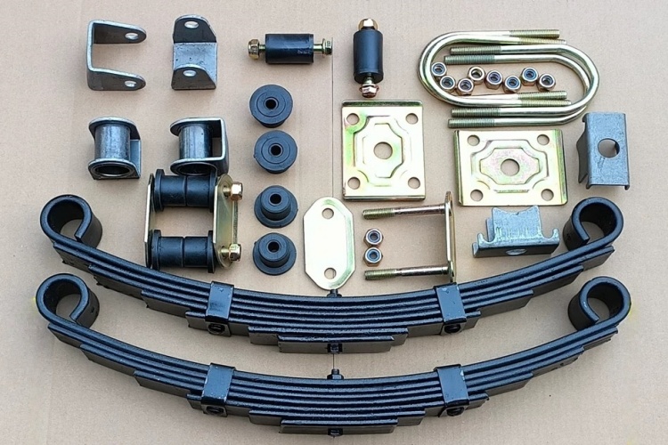 Detailed view of a multi-plate leaf spring assembly on an electric cargo trike chassis