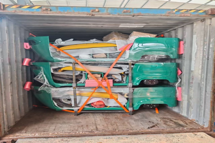 A photo of an electric rickshaw secured inside a custom steel packing frame